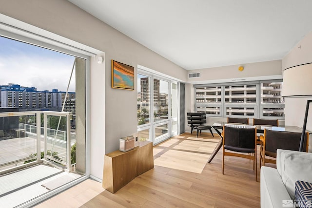 sunroom featuring a city view