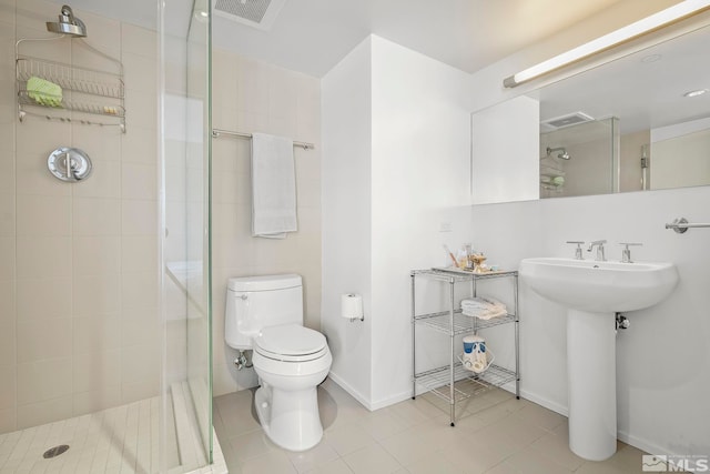 full bath featuring a shower stall, toilet, tile patterned flooring, and baseboards