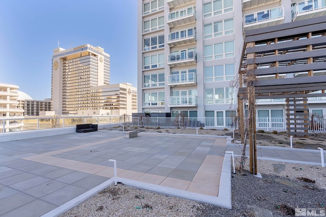 view of community with fence and a patio
