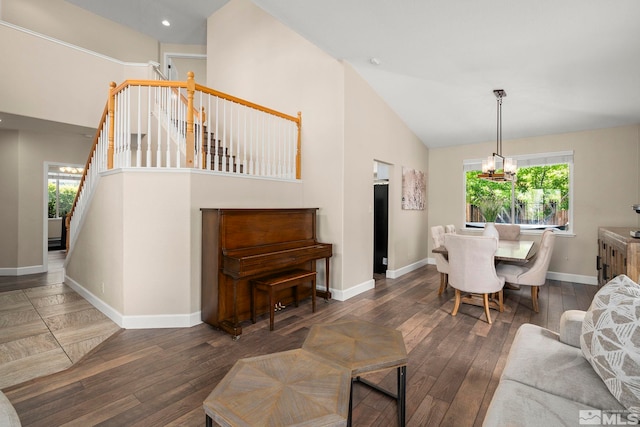 2963 Moose Ridge Dr, Reno, NV 89523 - living room featuring hardwood / wood-style flooring, a chandelier, baseboards, stairway, and high vaulted ceiling