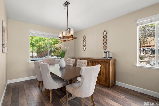 2963 Moose Ridge Dr, Reno, NV 89523 - dining room with a chandelier, plenty of natural light, dark wood-style flooring, and baseboards