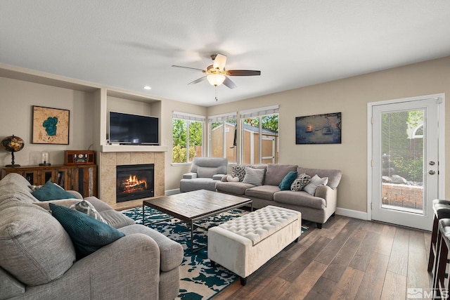2963 Moose Ridge Dr, Reno, NV 89523 - living room with dark wood-style flooring, a ceiling fan, baseboards, a fireplace, and plenty of natural light