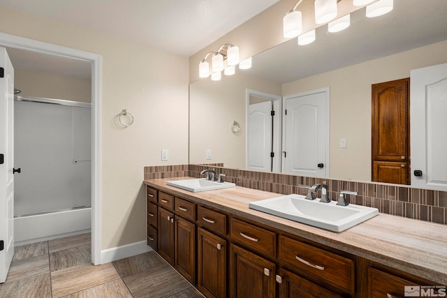2963 Moose Ridge Dr, Reno, NV 89523 - bathroom with decorative backsplash, double vanity, shower / bath combination with glass door, and baseboards
