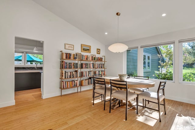 14250 Quiet Meadows Dr, Reno, NV 89511 - dining area featuring light wood-style flooring, recessed lighting, baseboards, and high vaulted ceiling