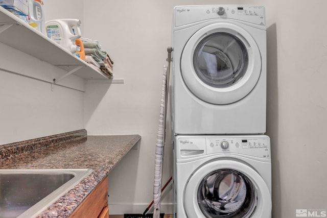 14250 Quiet Meadows Dr, Reno, NV 89511 - clothes washing area featuring stacked washer / drying machine and baseboards