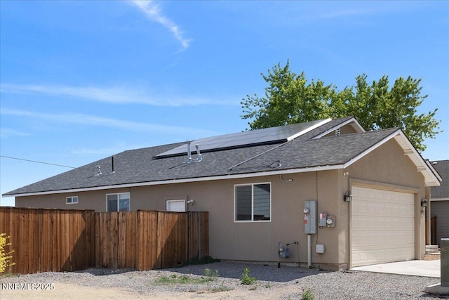 391A Bens Way, Fernley, NV 89408 - view of side of home with a garage, roof with shingles, solar panels, stucco siding, and concrete driveway