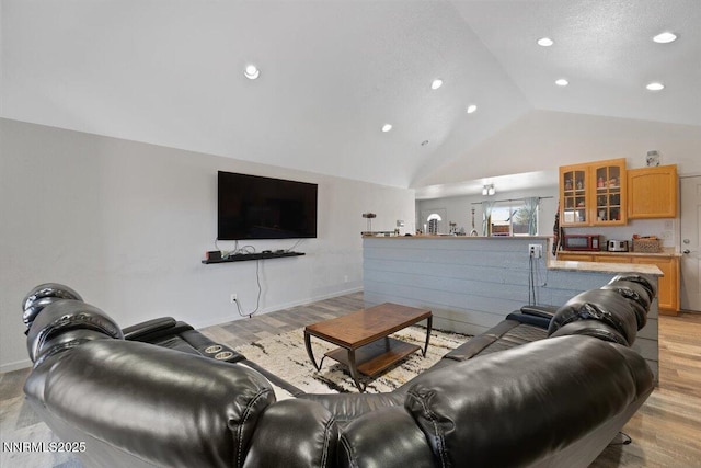 391A Bens Way, Fernley, NV 89408 - living area featuring vaulted ceiling, recessed lighting, light wood-style floors, and baseboards