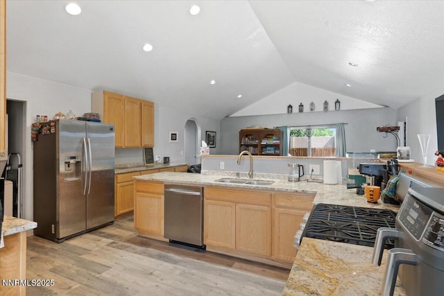 391A Bens Way, Fernley, NV 89408 - kitchen featuring stainless steel appliances, a sink, light brown cabinets, lofted ceiling, and arched walkways