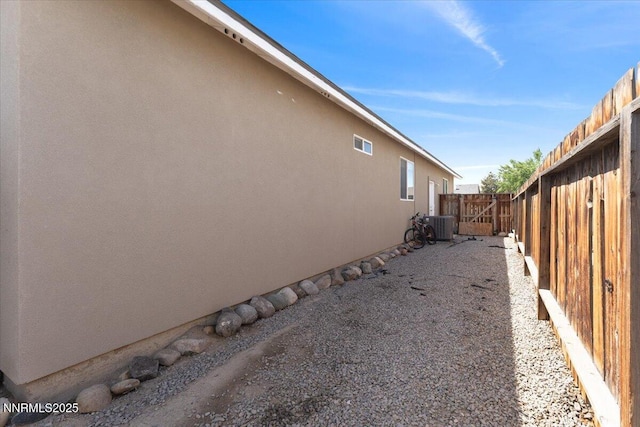 391A Bens Way, Fernley, NV 89408 - view of side of home featuring stucco siding, a fenced backyard, and central AC unit
