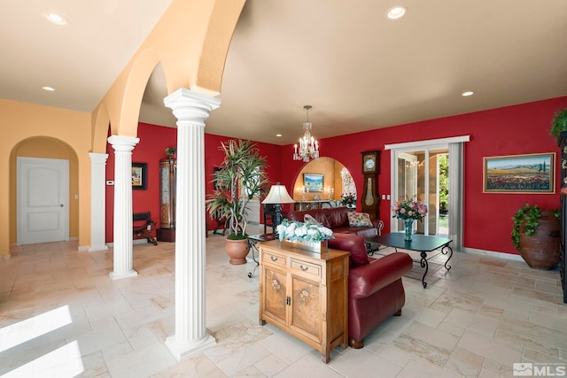 living room with decorative columns, recessed lighting, arched walkways, and baseboards
