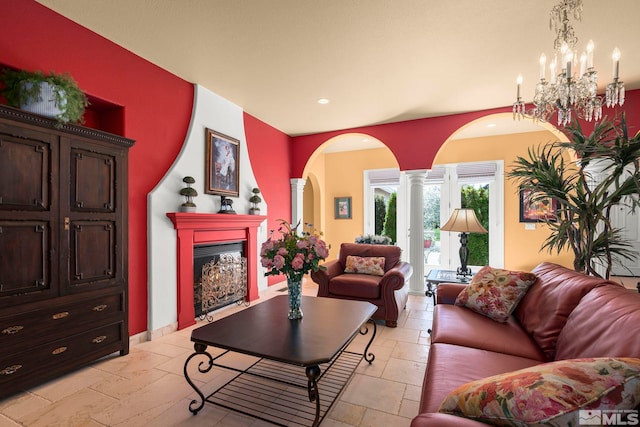 living room with arched walkways, stone tile floors, a fireplace, recessed lighting, and ornate columns