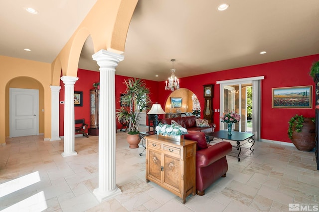 living room with decorative columns, recessed lighting, arched walkways, and baseboards