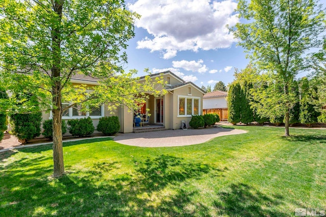 view of front of home with stucco siding and a patio