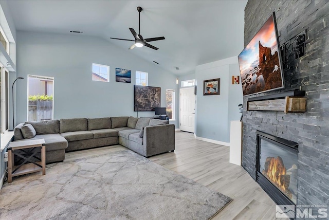 7766 Cerritos Cir, Sparks, NV 89436 - living area with high vaulted ceiling, ceiling fan, plenty of natural light, a fireplace, and wood finished floors