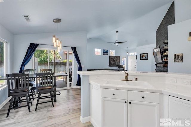 7766 Cerritos Cir, Sparks, NV 89436 - kitchen featuring dishwasher, healthy amount of natural light, tile countertops, vaulted ceiling, and a sink