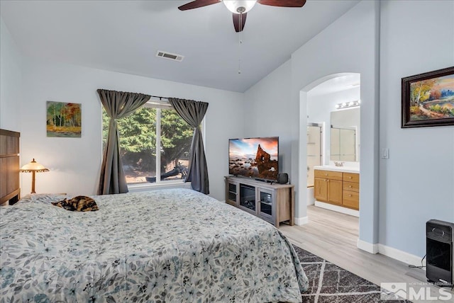 7766 Cerritos Cir, Sparks, NV 89436 - bedroom featuring arched walkways, light wood-type flooring, baseboards, vaulted ceiling, and heating unit