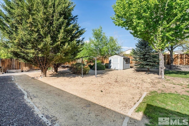 7766 Cerritos Cir, Sparks, NV 89436 - view of yard featuring a storage shed, fence, and an outbuilding