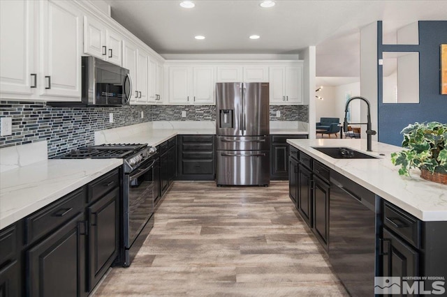 2160 Mammatus Dr, Sparks, NV 89441 - kitchen featuring appliances with stainless steel finishes, a sink, white cabinetry, dark cabinetry, and recessed lighting