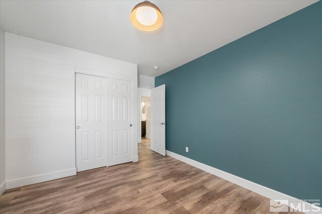 2160 Mammatus Dr, Sparks, NV 89441 - unfurnished bedroom featuring wood finished floors, baseboards, and a closet