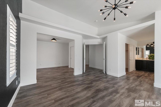 2160 Mammatus Dr, Sparks, NV 89441 - unfurnished living room featuring dark wood finished floors, a chandelier, and baseboards