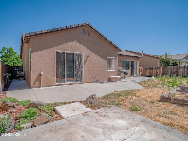 1840 Granite Chief Dr, Reno, NV 89521 - rear view of property with a patio area, a fenced backyard, stucco siding, and a vegetable garden