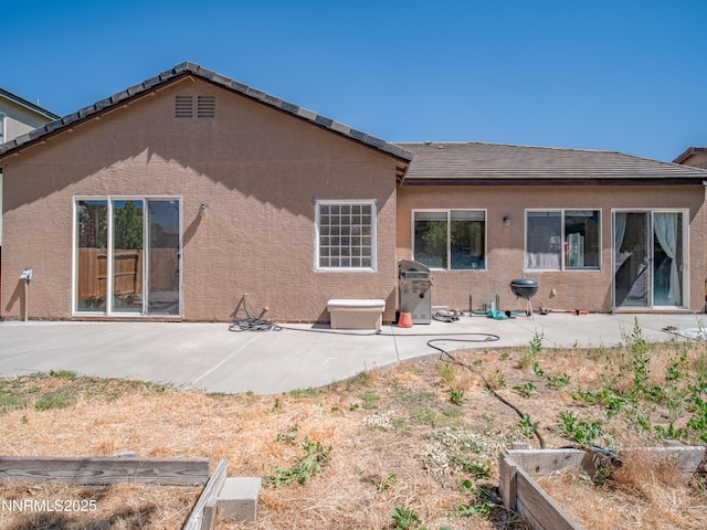 1840 Granite Chief Dr, Reno, NV 89521 - rear view of house with a patio area, stucco siding, and a vegetable garden