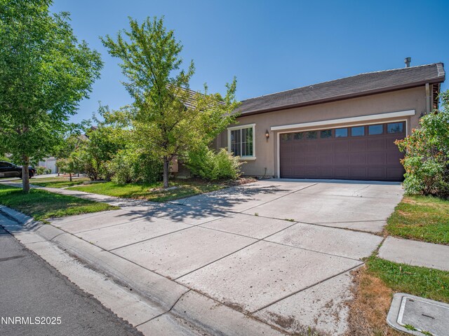 1840 Granite Chief Dr, Reno, NV 89521 - view of front of house with driveway, stucco siding, and an attached garage
