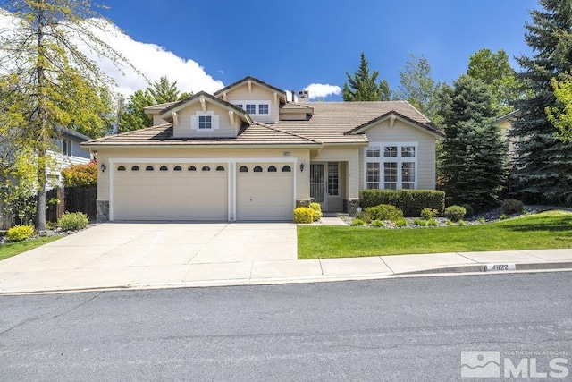 4822 Ramcreek Trl, Reno, NV 89519 - traditional home with an attached garage, concrete driveway, a tile roof, stone siding, and a front yard