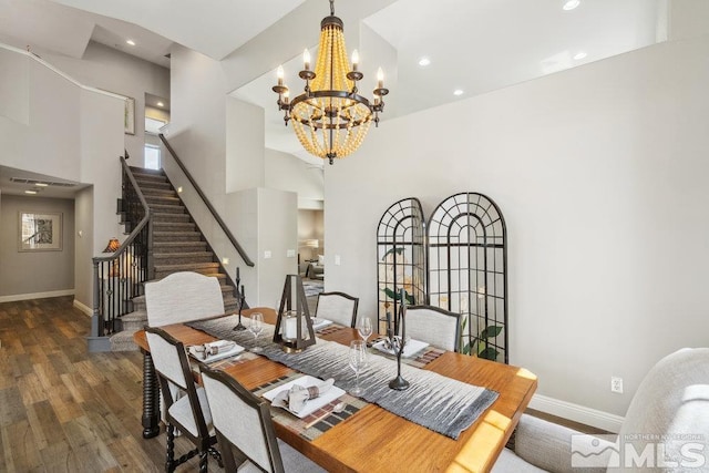 4822 Ramcreek Trl, Reno, NV 89519 - dining area with wood finished floors, stairs, a towering ceiling, a chandelier, and baseboards