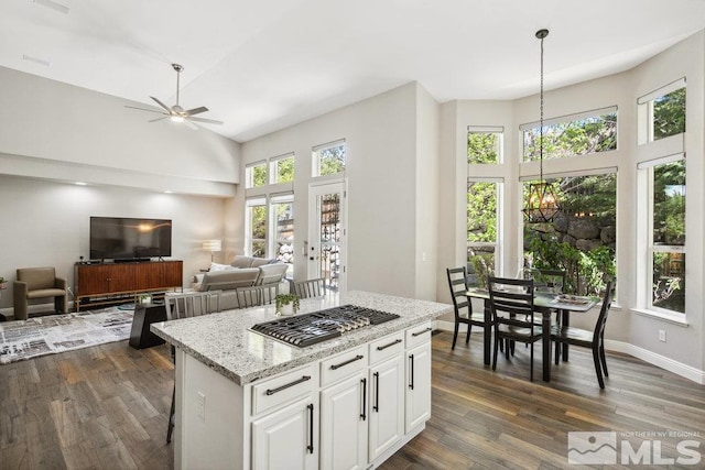 4822 Ramcreek Trl, Reno, NV 89519 - kitchen featuring high vaulted ceiling, a center island, dark wood-style floors, ceiling fan, and white cabinets