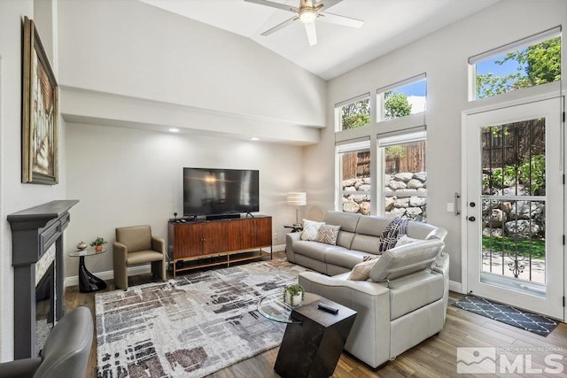 4822 Ramcreek Trl, Reno, NV 89519 - living room with a ceiling fan, high vaulted ceiling, wood finished floors, baseboards, and a fireplace