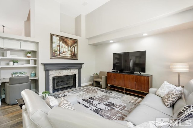 4822 Ramcreek Trl, Reno, NV 89519 - living area with a high end fireplace, a towering ceiling, baseboards, and light wood finished floors