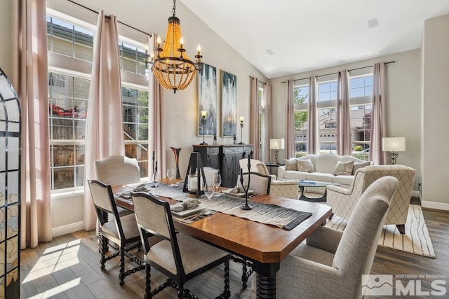 4822 Ramcreek Trl, Reno, NV 89519 - dining space featuring a chandelier, wood finished floors, baseboards, and vaulted ceiling
