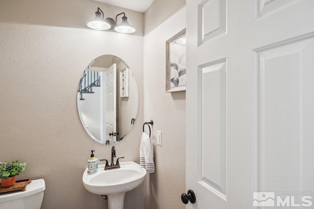4822 Ramcreek Trl, Reno, NV 89519 - half bath with toilet, a sink, and a textured wall