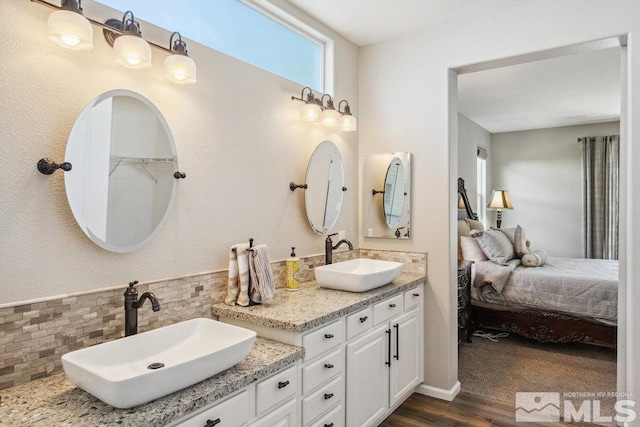 4822 Ramcreek Trl, Reno, NV 89519 - bathroom with ensuite bath, wood finished floors, backsplash, and double vanity