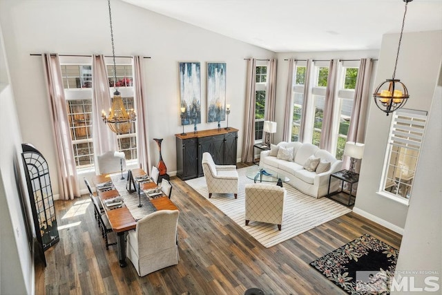 4822 Ramcreek Trl, Reno, NV 89519 - living room with a chandelier, wood finished floors, baseboards, and vaulted ceiling