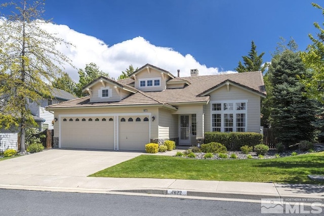 4822 Ramcreek Trl, Reno, NV 89519 - traditional home with a garage, driveway, a front yard, stone siding, and a tile roof