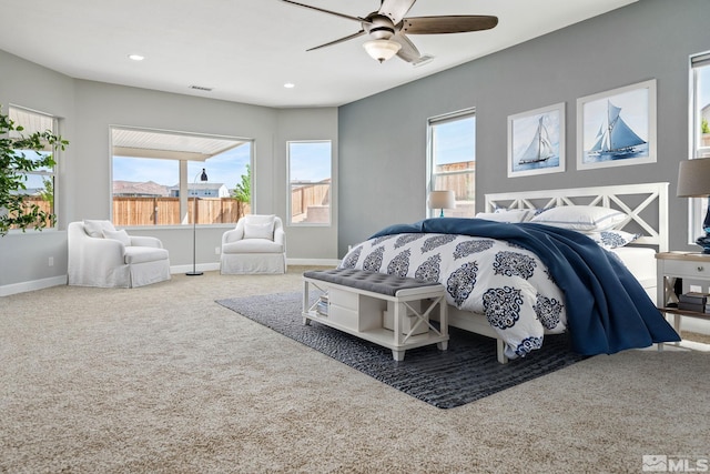 carpeted bedroom featuring multiple windows, baseboards, a ceiling fan, and recessed lighting