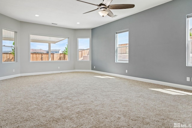 carpeted spare room with a ceiling fan, baseboards, and recessed lighting