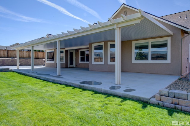 back of property featuring a patio area and stucco siding