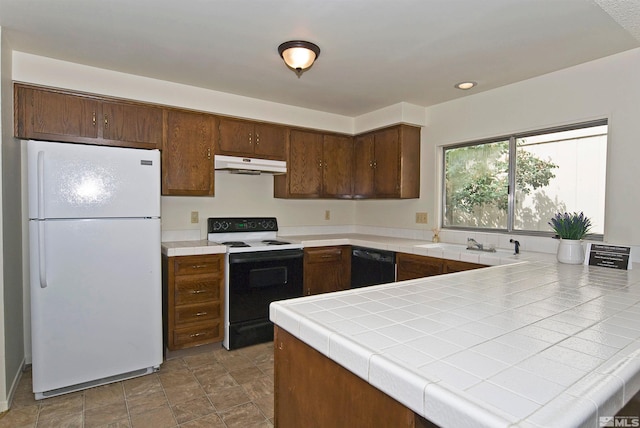 1476 Heather Ct, Sparks, NV 89434 - kitchen with freestanding refrigerator, electric range oven, under cabinet range hood, black dishwasher, and tile counters