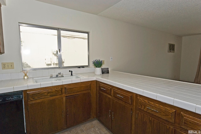1476 Heather Ct, Sparks, NV 89434 - kitchen with black dishwasher, a sink, light countertops, and a textured ceiling