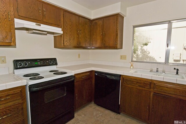 1476 Heather Ct, Sparks, NV 89434 - kitchen featuring electric range oven, dishwasher, under cabinet range hood, a sink, and brown cabinets