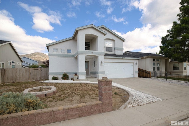 250 Corral Dr, Dayton, NV 89403 - view of front of property featuring stucco siding, concrete driveway, fence, and a garage