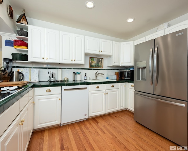 308 Thompson, Carson City, NV 89703 - kitchen with stainless steel appliances, tile counters, open shelves, white cabinetry, and recessed lighting