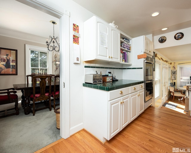 308 Thompson, Carson City, NV 89703 - kitchen with tile counters, white cabinetry, light wood-style floors, recessed lighting, and double oven
