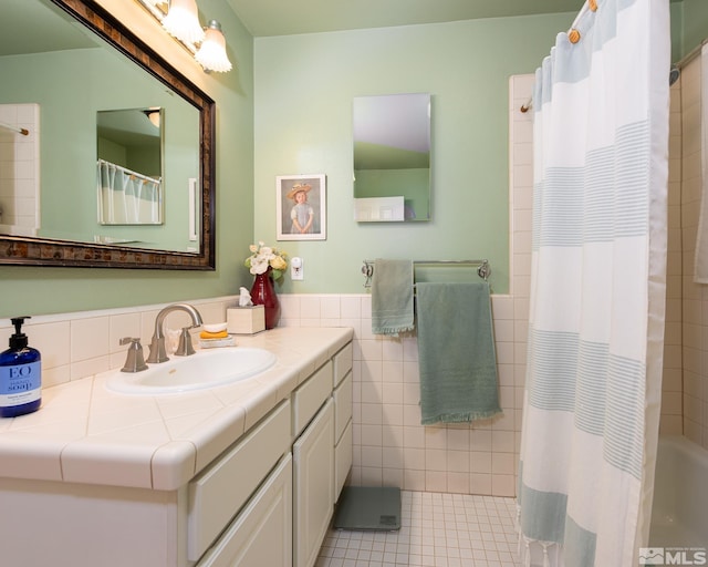 308 Thompson, Carson City, NV 89703 - bathroom featuring tile walls, curtained shower, vanity, tile patterned flooring, and wainscoting