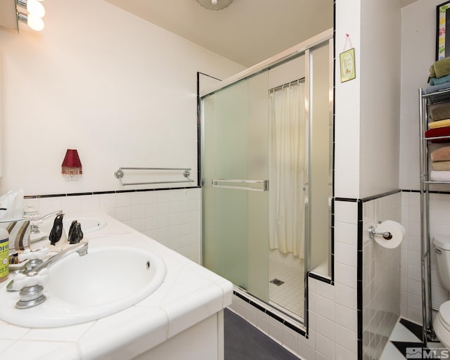 308 Thompson, Carson City, NV 89703 - full bath with tile walls, a stall shower, toilet, tile patterned floors, and wainscoting