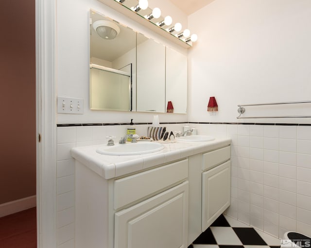 308 Thompson, Carson City, NV 89703 - bathroom with tile walls, double vanity, a wainscoted wall, and a shower with door