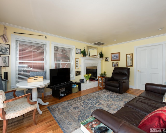 308 Thompson, Carson City, NV 89703 - living room featuring a fireplace, wood finished floors, and crown molding